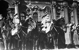 Commander of the Petrograd military district General L. Kornilov, right, takes the salute on Palace Square © Sputnik